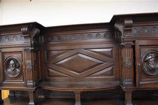 A late 19th century large carved oak breakfront sideboard, W.7ft 9in.